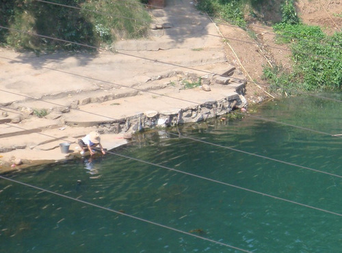 Washing clothes in the river.